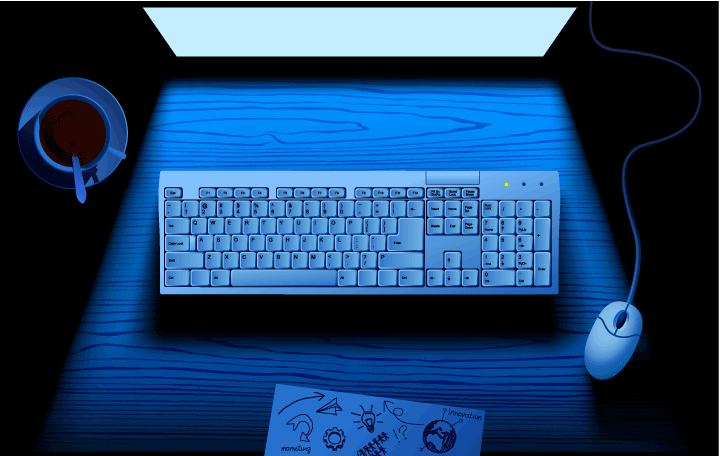 Computer keyboard on table illuminated by blue light of monitor screen Licensed Computer keyboard on table illuminated by blue light of monitor screen