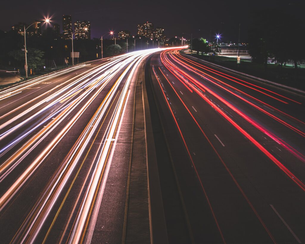 long exposure of cars driving along a road at night